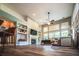 Spacious living room with large windows, fireplace, built-in shelving, and hardwood floors at 808 Long Drive Rd, Summerville, SC 29485
