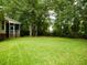 Expansive backyard featuring lush green lawn and mature trees, perfect for outdoor activities and relaxation at 8316 Dye Makers, North Charleston, SC 29418