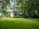 Well-maintained backyard showcasing a spacious lawn, screened porch, and the home's exterior with classic design elements at 8316 Dye Makers, North Charleston, SC 29418