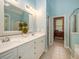 Bright bathroom with double vanity, white cabinets, walk-in shower, and linen closet at 8316 Dye Makers, North Charleston, SC 29418