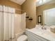 Bathroom with shower-tub combo and white vanity with mirror at 8316 Dye Makers, North Charleston, SC 29418