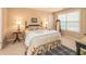 Bedroom with decorative lamps, patterned linens, and light-filled window at 8316 Dye Makers, North Charleston, SC 29418