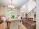 Open-concept dining room featuring natural light, wooden floors, and stylish decor with access to the foyer at 8316 Dye Makers, North Charleston, SC 29418
