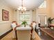 Bright dining room with a chandelier and natural light spilling in from the tall windows at 8316 Dye Makers, North Charleston, SC 29418
