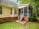 Charming home exterior featuring a screened porch and a manicured lawn at 8316 Dye Makers, North Charleston, SC 29418