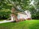 A view of the rear corner of this home with a large backyard and lush plantings at 8316 Dye Makers, North Charleston, SC 29418