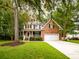 Inviting home with a blend of brick and siding, a two-car garage, and lush green landscaping at 8316 Dye Makers, North Charleston, SC 29418