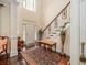 Welcoming foyer featuring dark hardwood floors, tall ceilings and stairway leading to the second floor at 8316 Dye Makers, North Charleston, SC 29418