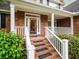 Close-up of the brick front porch and white railing with a decorative glass front door at 8316 Dye Makers, North Charleston, SC 29418