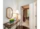 Hallway with wooden floors, decorated table, mirror, and an open door leading to an office at 8316 Dye Makers, North Charleston, SC 29418
