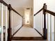 Hallway with dark wood railing and white spindles at 8316 Dye Makers, North Charleston, SC 29418