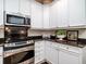 Bright, modern kitchen with stainless appliances, white cabinets and dark granite countertops at 8316 Dye Makers, North Charleston, SC 29418