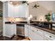 Well-lit kitchen featuring stainless steel dishwasher and sink, and white cabinets with dark granite countertops at 8316 Dye Makers, North Charleston, SC 29418