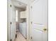 Functional laundry room with white cabinets, tiled floors, and washer/dryer at 8316 Dye Makers, North Charleston, SC 29418
