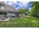Spacious backyard with a patio, lush grass, and screened in porch, perfect for entertaining at 8721 Grassy Oak Trl, North Charleston, SC 29420