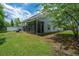 Backyard view of property featuring screened in porch and fenced yard at 8721 Grassy Oak Trl, North Charleston, SC 29420