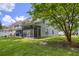 This home features a well maintained lawn with mature trees and a screened in porch at 8721 Grassy Oak Trl, North Charleston, SC 29420