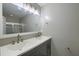 Modern bathroom featuring a double sink vanity, updated lighting, and a framed mirror at 8721 Grassy Oak Trl, North Charleston, SC 29420