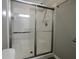 Modern bathroom featuring tiled shower with sliding glass doors and built-in seat at 8721 Grassy Oak Trl, North Charleston, SC 29420