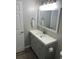 Bathroom featuring modern vanity with mirror, light fixture, and gray cabinets at 8721 Grassy Oak Trl, North Charleston, SC 29420
