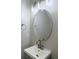 Bathroom vanity with round mirror, modern lighting, and chrome fixtures at 8721 Grassy Oak Trl, North Charleston, SC 29420