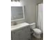 Bathroom features vanity, mirror and shower curtain with light gray walls at 8721 Grassy Oak Trl, North Charleston, SC 29420