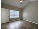 Light-filled bedroom with vaulted ceilings, modern fan and lovely wood-look flooring at 8721 Grassy Oak Trl, North Charleston, SC 29420