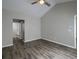 Bright bedroom with vaulted ceiling, vinyl flooring, a ceiling fan, and a conveniently attached bathroom at 8721 Grassy Oak Trl, North Charleston, SC 29420