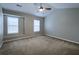 Bright bedroom features a vaulted ceiling, two windows, and neutral paint at 8721 Grassy Oak Trl, North Charleston, SC 29420