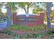 The Coosaw Commons community entrance features attractive brick signage surrounded by landscaped greenery at 8721 Grassy Oak Trl, North Charleston, SC 29420