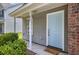 This home features a charming light blue front door and fresh landscaping at 8721 Grassy Oak Trl, North Charleston, SC 29420