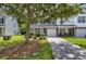 Inviting townhome with well-maintained landscaping, a single car garage, and a covered porch at 8721 Grassy Oak Trl, North Charleston, SC 29420