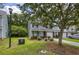 Charming townhome featuring a well-manicured front lawn, mature tree, brick accents, and beautiful curb appeal at 8721 Grassy Oak Trl, North Charleston, SC 29420