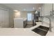 Open kitchen with stainless steel sink, white countertops, light gray cabinets, and stainless appliances at 8721 Grassy Oak Trl, North Charleston, SC 29420