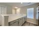 Kitchen with white countertops, light gray cabinets, stainless steel appliances, and views to front entry at 8721 Grassy Oak Trl, North Charleston, SC 29420