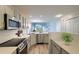 Modern kitchen with stainless steel appliances, sleek countertops, subway tile backsplash, and an open view to the living area at 8721 Grassy Oak Trl, North Charleston, SC 29420