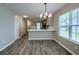 Bright kitchen/dining area featuring stainless steel appliances, gray cabinets, and stylish chandelier at 8721 Grassy Oak Trl, North Charleston, SC 29420