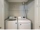Laundry area features white washer and dryer, wire shelving, and access door at 8721 Grassy Oak Trl, North Charleston, SC 29420