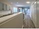 View from kitchen to dining/living area and stairway with gray cabinets and stainless steel appliances at 8721 Grassy Oak Trl, North Charleston, SC 29420