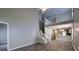 Open-concept living room with lots of natural light, high ceilings, a staircase to the upper level, and views into the kitchen at 8721 Grassy Oak Trl, North Charleston, SC 29420