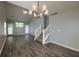 Bright living room with vaulted ceilings, hardwood floors and a modern chandelier at 8721 Grassy Oak Trl, North Charleston, SC 29420