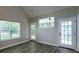 Bright living room with vaulted ceilings, large windows, and French doors to the exterior at 8721 Grassy Oak Trl, North Charleston, SC 29420