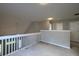 The open loft area features fresh paint and neutral carpeting with a view of the backyard at 8721 Grassy Oak Trl, North Charleston, SC 29420