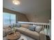Cozy upstairs living area featuring a comfortable sectional sofa, views of the outdoors, and plenty of natural light at 8721 Grassy Oak Trl, North Charleston, SC 29420