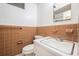 Bathroom featuring a ceramic tile wall, mirror and updated fixtures at 943 Mikell Dr, Charleston, SC 29412