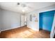 Bedroom with hardwood floors, blue closet, two windows, and ceiling fan at 943 Mikell Dr, Charleston, SC 29412