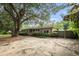 Single story brick home with light blue shutters and a large front yard at 943 Mikell Dr, Charleston, SC 29412