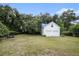 Detached two-car garage situated in a spacious backyard with mature trees and a picnic table at 943 Mikell Dr, Charleston, SC 29412