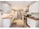 This kitchen features white cabinets, butcher block countertops and stainless steel appliances at 943 Mikell Dr, Charleston, SC 29412