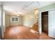 Spacious living room with hardwood floors, natural light, ceiling fan, closet, and stairs at 943 Mikell Dr, Charleston, SC 29412
